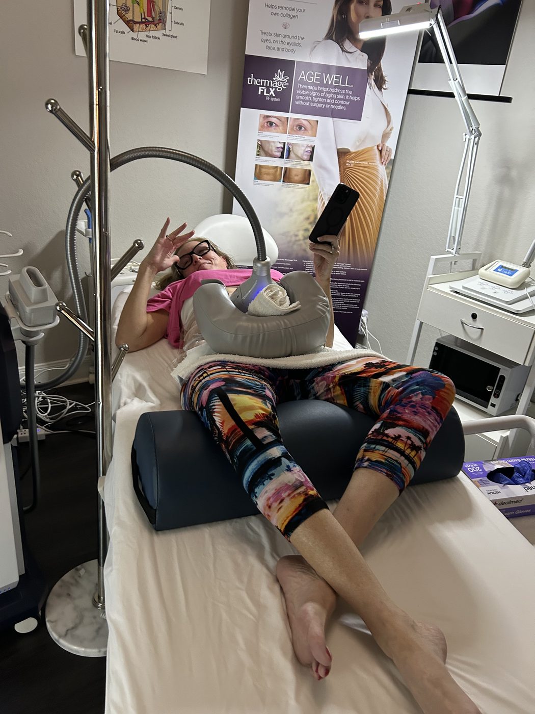 A smiling guest mid-CoolSculpting session at Rejuva Haven