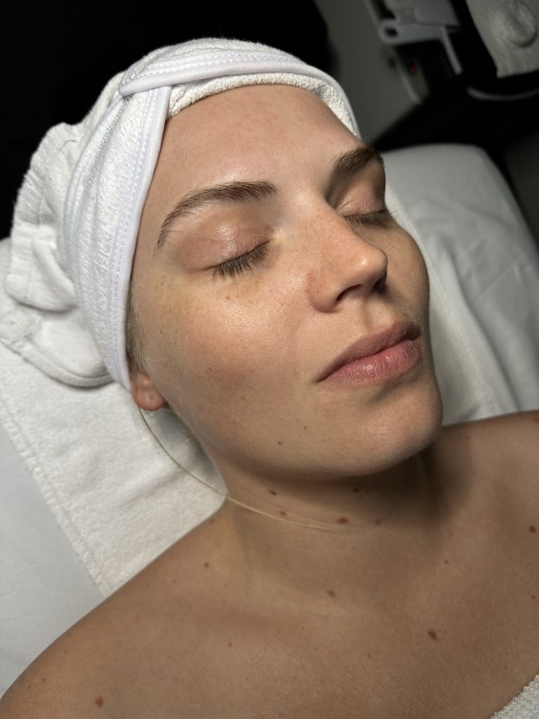 A guest resting, skin prepped, during her visit in the private treatment room