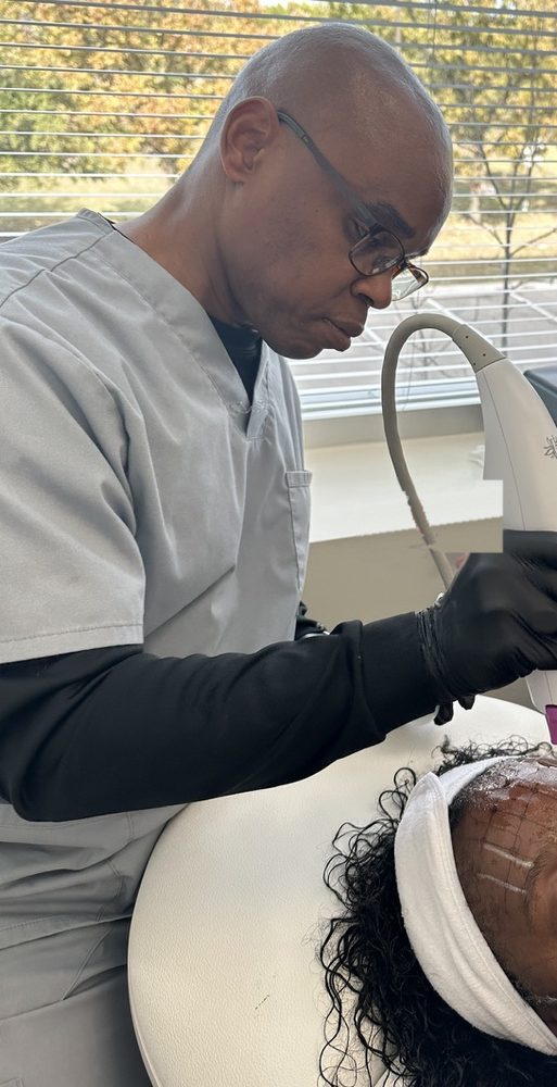 Steve Cornelius administering Thermage FLX to his wife Linda, who assists in the practice